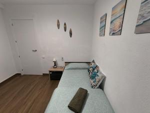 ein kleines Zimmer mit zwei Betten und einem Tisch in der Unterkunft Habitaciones baratas, Cerca de la Plaza de Toros in Alicante + 11 Fotos