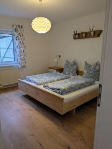 a bedroom with a large bed and a window at Ferienwohnung Ramona - idyllisch und charmant in Kirchdorf im Wald