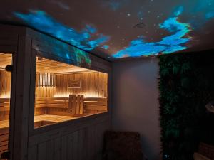 a room with a window with blue lights on the ceiling at Waldklang-Suite in Bad Koetzting
