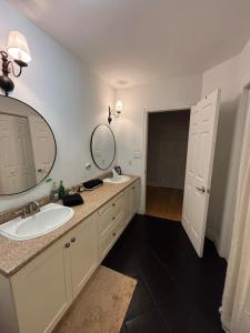 a bathroom with two sinks and a large mirror at Tackle Box Retreat in Deseronto
