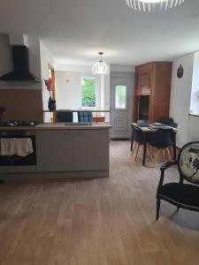 a kitchen and dining room with a table and chairs at Maison de campagne in Aignay-le-Duc