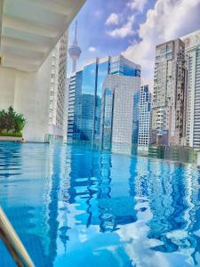 a swimming pool in a city with tall buildings at One Service Suites KLCC in Kuala Lumpur