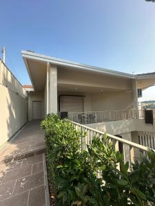 a house with a walkway in front of it at Colle del Mare in Gabicce Mare +2 photos