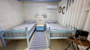 a bedroom with two beds and a desk at Old soul, Sea views in Dhërmi