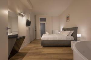a bedroom with a bed and a tub and a sink at Il Fontanile in Como