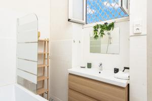 a bathroom with a sink and a mirror at Le charme au coeur de Menton! in Menton