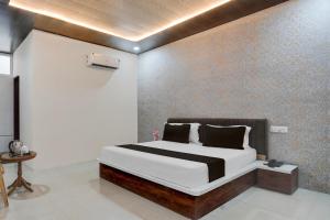 Ένα ή περισσότερα κρεβάτια σε δωμάτιο στο Hotel O Asthara