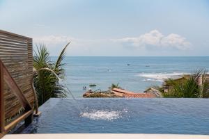 a swimming pool with a view of the ocean at Pousada Vila Dos Mares in Morro de São Paulo