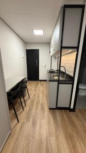 a room with a kitchen and a table and chairs at Residencial Roberto Luiz Chiodi in Campos Novos