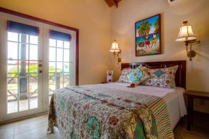 a bedroom with a bed and a window with a view at X'tan Ha- The Waterfront in San Pedro