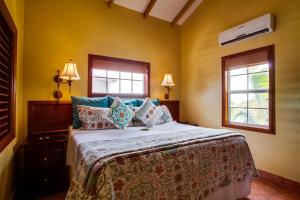 a bedroom with a bed and two windows at X'tan Ha- The Waterfront in San Pedro