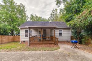 a small white house with a porch and a fence at Home with Pet-Friendly Yard, 1 Mi to Dtwn Raleigh! in Raleigh