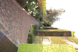 a garden with a brick wall and some stairs at GBL Reine Chateau in Polokwane +11 photos