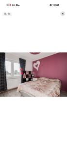 a bedroom with a bed with a heart on the wall at Heby in Heby