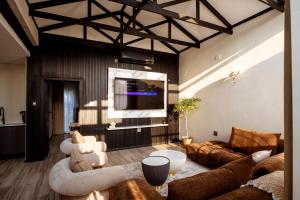 a living room with a couch and a tv at The Pinnacle Polokwane in Polokwane