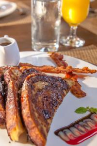 a plate of food with bacon and meat on a table at X'tan Ha- The Waterfront in San Pedro