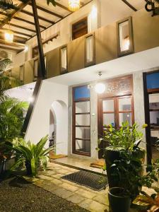 a house with a courtyard with plants in front of it at Sunray Village Dalawella in Unawatuna