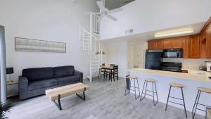 a living room with a couch and a kitchen at Lovely 2 bedroom condo with pool J3 in Little River