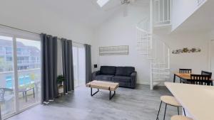 a living room with a couch and a table at Lovely 2 bedroom condo with pool J3 in Little River