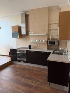 a large kitchen with a sink and a stove at Квартира в центре in Dnipro