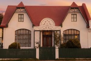 a white house with a red roof at Patagonia Heritage Home in Punta Arenas