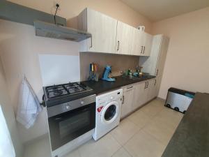 a kitchen with a stove and a washing machine at Laaglandlaan 1 in Antwerp +1 photo