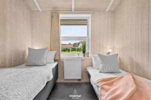 Ένα ή περισσότερα κρεβάτια σε δωμάτιο στο Ferienhaus Poolhaus Schönhagen