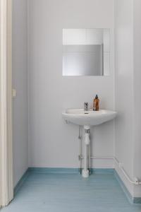 a bathroom with a white sink and a mirror at Newly Furnished Apartment Kopparberg Train Station in Kopparberg