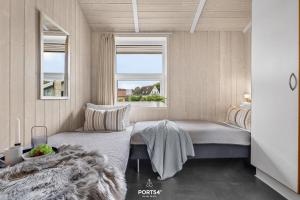 Ένα ή περισσότερα κρεβάτια σε δωμάτιο στο Ferienhaus Poolhaus Schönhagen +6 φωτογραφίες