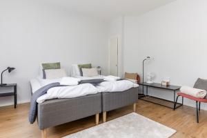 a bedroom with a large bed with two tables at Newly Furnished Apartment Kopparberg Train Station in Kopparberg