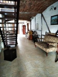 a living room with a couch and a staircase at Agroturystyka Agro Greupner in Jemielnica