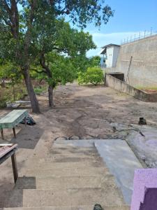 a park with a bench and trees and a building at Casa Brisa do Tapajós in Santarém +2 photos