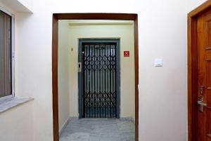 a door with a black gate in a building at Hotel O Eco Inn in Jojera