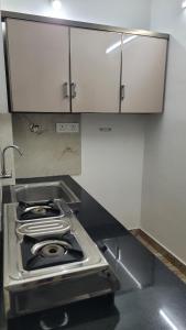 ein Herd mit Backofen in einer Küche mit Schränken in der Unterkunft YandY in Ernakulam