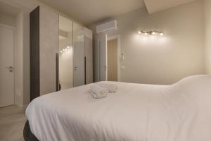 a bedroom with a white bed with two towels on it at La Sorgente in Como