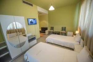 A bed or beds in a room at Luani A Hotel