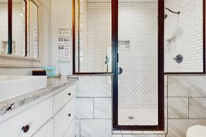 a bathroom with a shower and a sink at Packsaddle Beach House in Rockport +17 photos