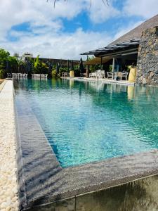 a swimming pool in front of a resort at Asmara Mauritius Oceanfront Retreat in Petite Case Noyale