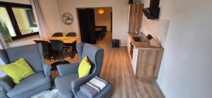 a living room with a couch and a table at Haus Im Wald 