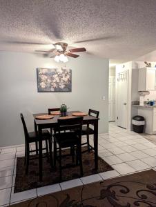a dining room table with chairs and a ceiling fan at Paradise Beach West in Indialantic