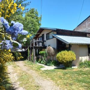 una casa con un camino de grava delante de ella en Cabañas Los Nonos, en El Bolsón