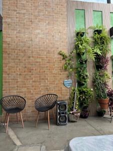 a patio with two chairs and a speaker next to a brick wall at Espaço Varanda in Sao Paulo +13 photos
