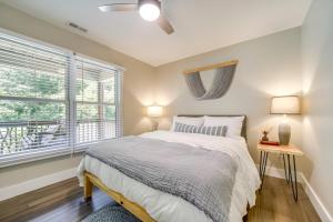 a bedroom with a bed and a window at Deck and Mtn Views Riverfront Cullowhee Home in Cullowhee