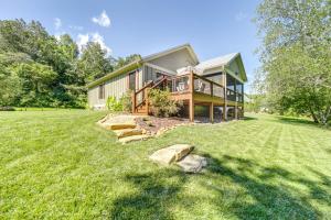 a house with a large yard in front of it at Deck and Mtn Views Riverfront Cullowhee Home in Cullowhee