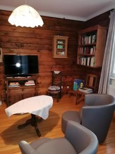 TV a/nebo společenská místnost v ubytování À L'ancienne Boulangerie - Chambres