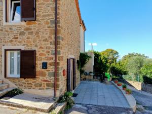 a brick building with a door and a window at da Roy in Scansano