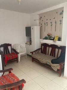 a kitchen with two chairs and a refrigerator at Starfish in Paracas