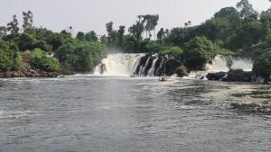 a group of people in a boat in a river with a waterfall at Villa le chant des Alizés 
