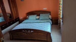 a bedroom with two beds and a mirror at Villa le chant des Alizés 