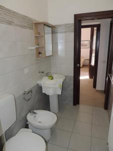 a bathroom with a toilet and a sink at Case Maiolica in Piano Conte +77 photos